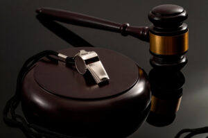 a gavel and a whistle on a whistleblower protection lawyer’s desk
