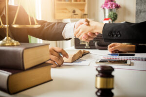 Client shakes hand with Hartford sex and gender discrimination lawyer during free consultation.