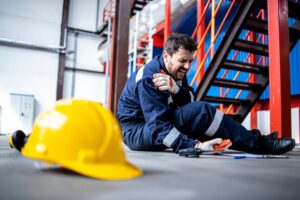 A worker holds his shoulder after suffering an injury on the job and wonders: Can you be fired for refusing to work in unsafe conditions?