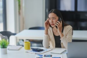 A young professional woman wondering if you can be fired for not working overtime.