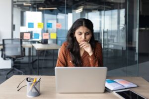 A businesswoman wondering if it’s legal to require unpaid overtime.